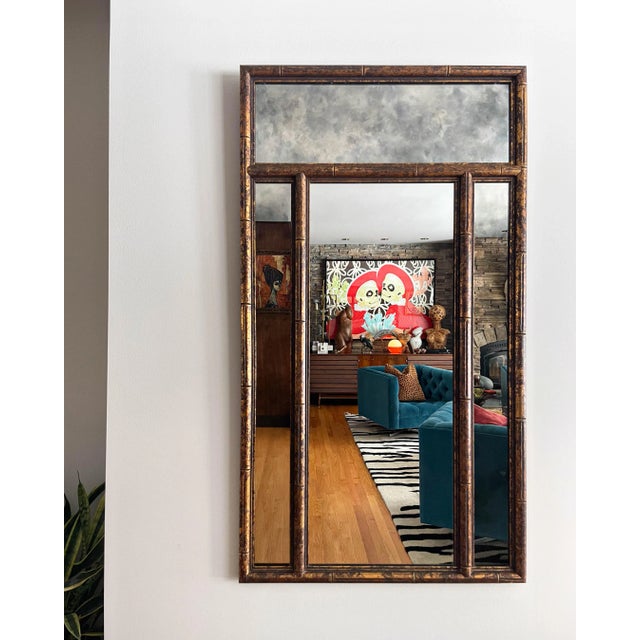 Large faux bamboo mirror with gilt tortoise finish and smoked mirrors around a clear central mirror.