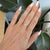 A natural Ethiopian opal shimmers with flashes of rainbow play-of-color in this cabochon ring, accented with diamonds in...