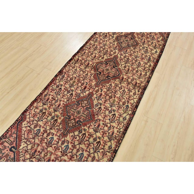 An authentic vintage tribal Hamedan runner hand-knotted with fine wool and natural dyes. This nomadic oriental rug...