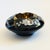 A vintage brass and black lacquered ashtray. Lovely inlaid floral mother of pearl design around the sides with a brass...