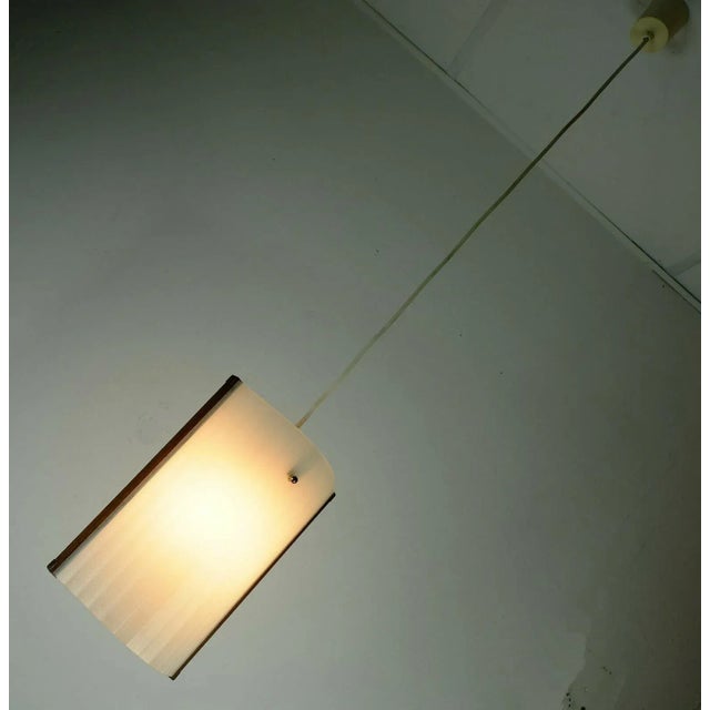 Very beautiful elegant Danish modern hanging lamp from the 50s / 60s. Screen of white glass with fine groove decor. Frame...