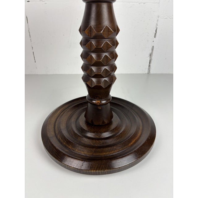 Round pedestal side table from France, in the manner of Charles Dudouyt. The top is a solid wood disc with a rounded,...
