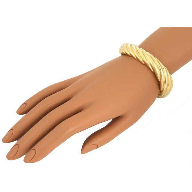 This is a beautiful 14k yellow gold hinged bangle bracelet, it is hallow with a puffed dome shape and has large slanted...