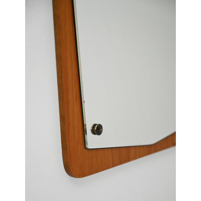 Swedish mirror from the 1960s with a teak frame and a contoured mirror surface. Original manufacturer's label present....