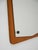 Swedish mirror from the 1960s with a teak frame and a contoured mirror surface. Original manufacturer's label present....