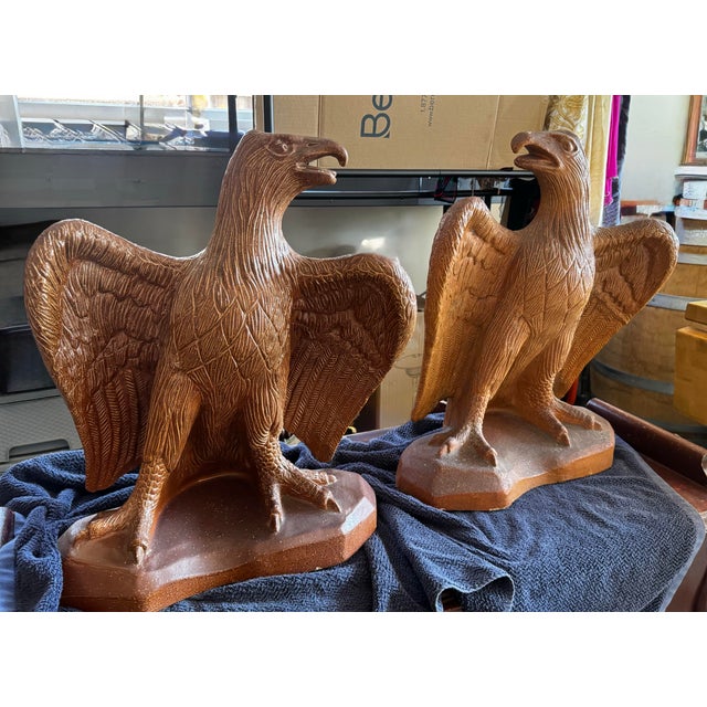 Impressive pair of large vintage glazed terra cotta Federal eagle sculptures, each standing approximately 23” tall. These...