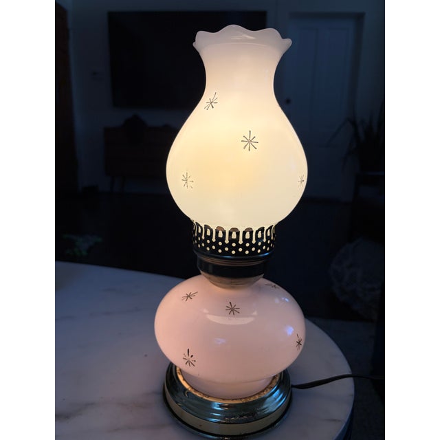 Charming vintage Mid-Century hurricane lamp featuring white milk glass decorated with scattered gold atomic starburst...