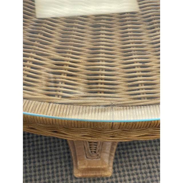 Gorgeous vintage round wicker dining table on. Pedestal base and glass cover on top.