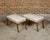 A pair of English Regency period mahogany rectangular stools from the 19th century with saber legs and custom upholstery....