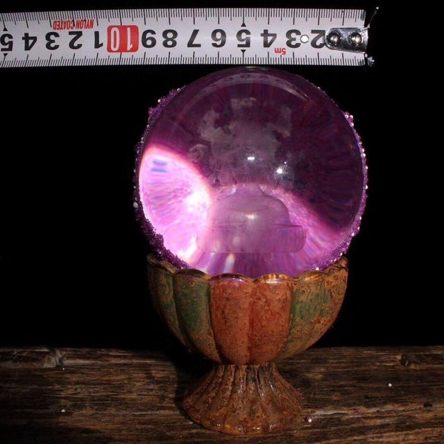 This is a rare and unusual Buddhist relic sphere, described as a "regenerated sarira" containing an etched image of a...