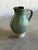 Vintage Mid-Century Modern ceramic pitcher jar features a striking organic aesthetic with a bulbous silhouette and an...