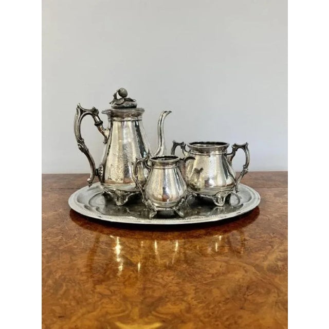 Antique Victorian three piece tea set and tray consisting of a silver plated ornate tea pot, sugar bowl and milk jug...