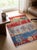 A small hand-knotted Gabbeh rug in the Persian Gabbeh tradition, built up as a landscape in four bands — madder red, sage...