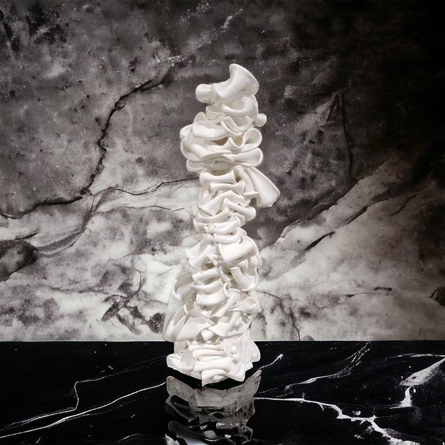 The justfurnituress studio offers plastic recycled products The sculpture similar to a large silk ribbon that winds...