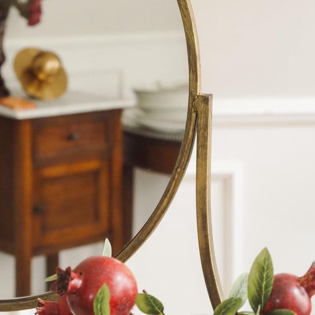 The console table is a newly produced piece of furniture made of brass-colored square tubing with an inset clear glass top...
