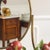 The console table is a newly produced piece of furniture made of brass-colored square tubing with an inset clear glass top...