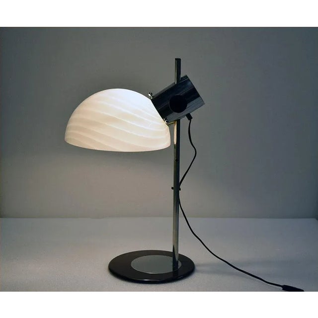 Table lamp produced by Zonca, 1970s. Structure in chromed and painted metal, diffuser in blown glass adjustable in height....