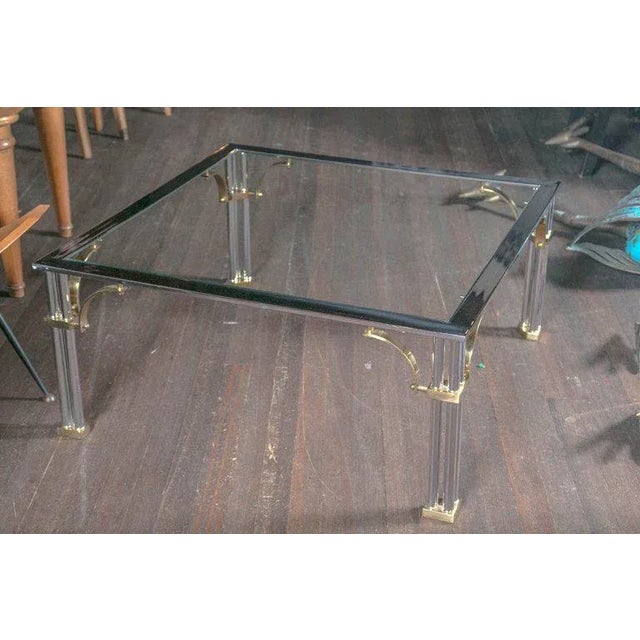 Square brass and chrome glass top cocktail table.