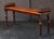 A fine English hall bench or window seat or stool of mahogany from the Regency era, featuring turned handles at opposing...