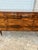 A striking French Art Deco Modern sideboard crafted in exotic Macassar ebony veneer, showcasing dramatic bookmatched grain...