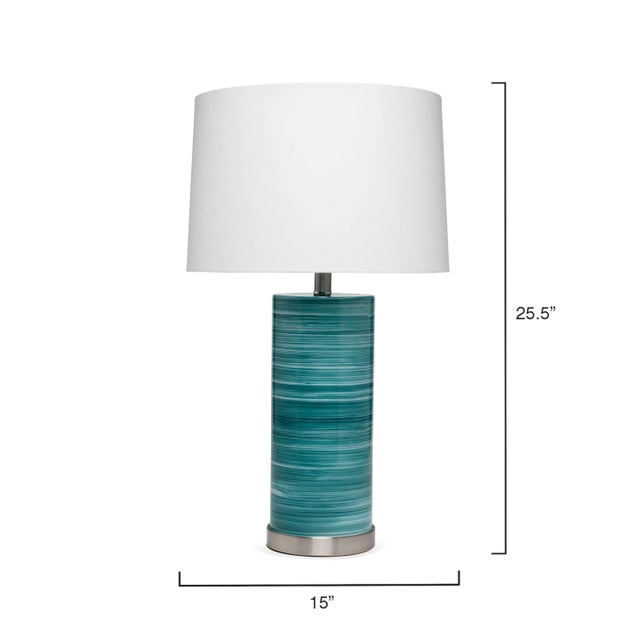 Striated layers of swirling glass, from marine blues to pale sky blues. Artisan mouth blown and crafted on a acrylic base....