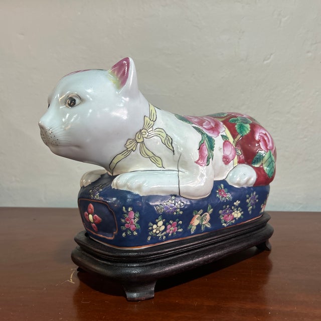 Beautiful vintage famille rose ceramic cat sculpture in wooden base.