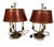 A handsome pair of traditional toleware bouillotte lamps, dating to the early 20th century and inspired by the elegant...