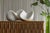This sculptural object, carved from luminous Carrara marble, presents itself as a quiet yet assured meditation on balance,...