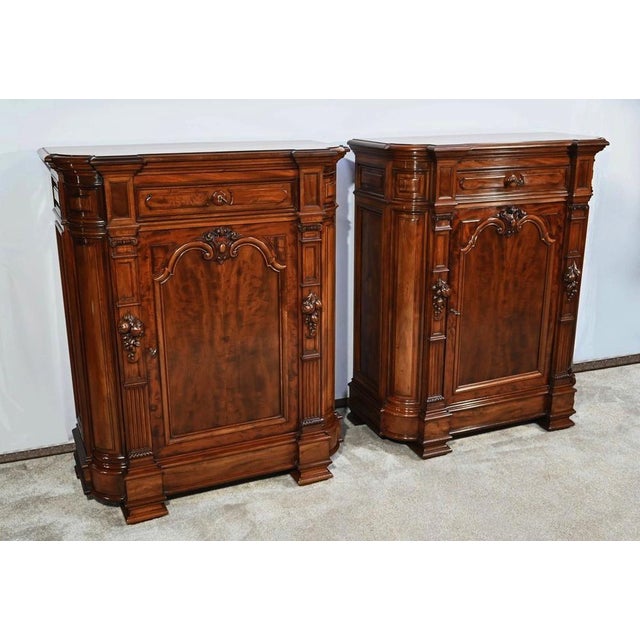 Pair of identical and richly carved Parisian -manufacturing mahogany support furniture. Each of these furniture presents a...