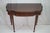 This exquisite 1920s American Sheraton console table, crafted from rich mahogany, epitomizes antique elegance. The table...