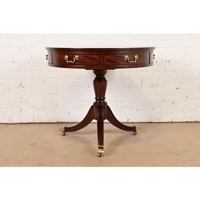 A gorgeous Georgian or Regency style pedestal drum side table or tea table By Baker Furniture USA, Circa 1980s Flame...