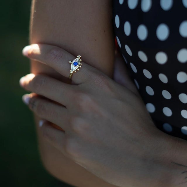 The Mystic Amethyst Evil Eye Gold Adjustable Band Ring radiates spiritual energy and timeless elegance. The rich purple...