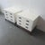 This pair of Henredon end tables features a clean white finish, three spacious drawers, and elegant brass ring pulls. The...