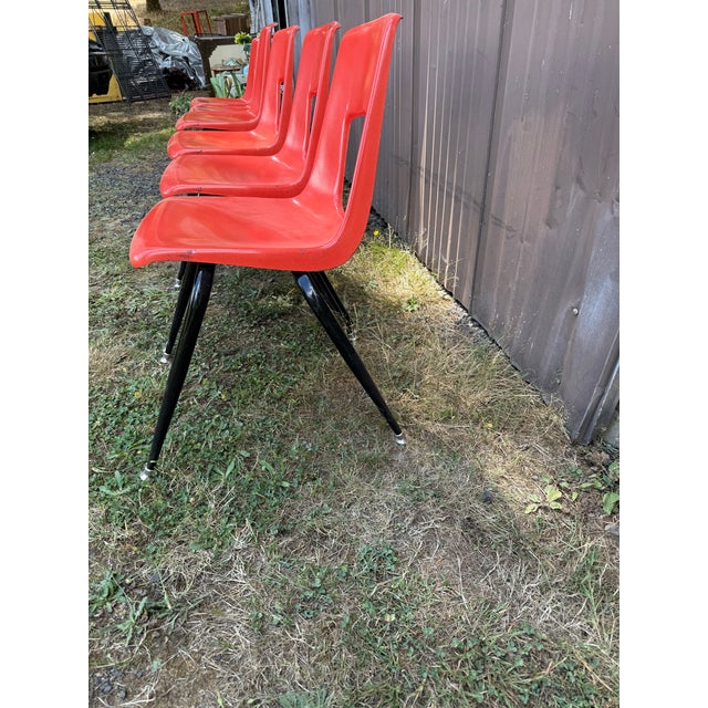 Set of 6 full-sized vintage ARTCO BELL CO bucket HARD PLASTIC CHAIR Mid Century retro orange with black metal frame and legs.