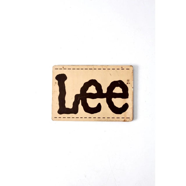 A charming piece of vintage American advertising, this Lee sign features the brand’s iconic classic logo in warm tan and...
