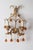 This Vintage florentine pair of wall lamps is made up of glass, metal coated with gold. Each wall lamp has two bulb...