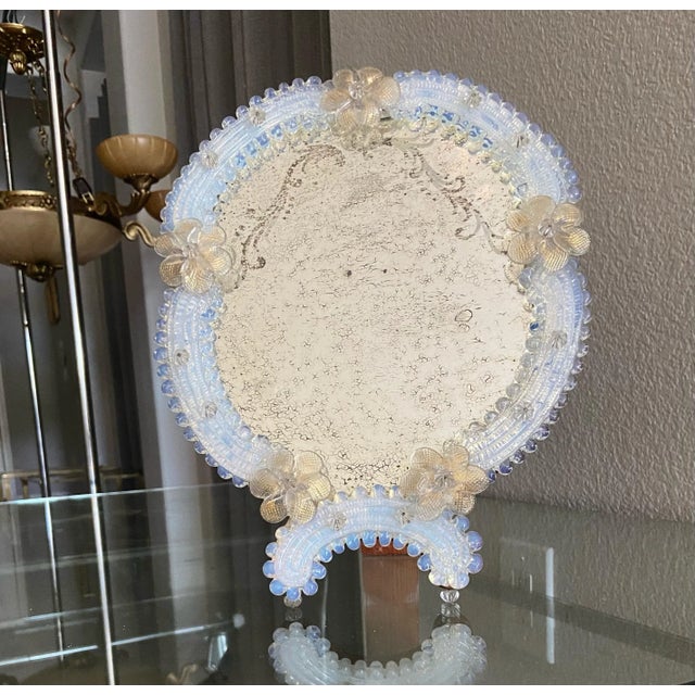 Murano vanity table mirror with clear and gold flowers, and opalescence color glass pieces surrounding the mirror. Mirror...