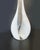 Elegant vase in white and transparent Murano glass characterized by a long neck and a "pear" shape. The set is available...