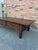 This is a 19th Century French dark oak coffee table featuring two drawers, both with brass pull hardware and keyhole...