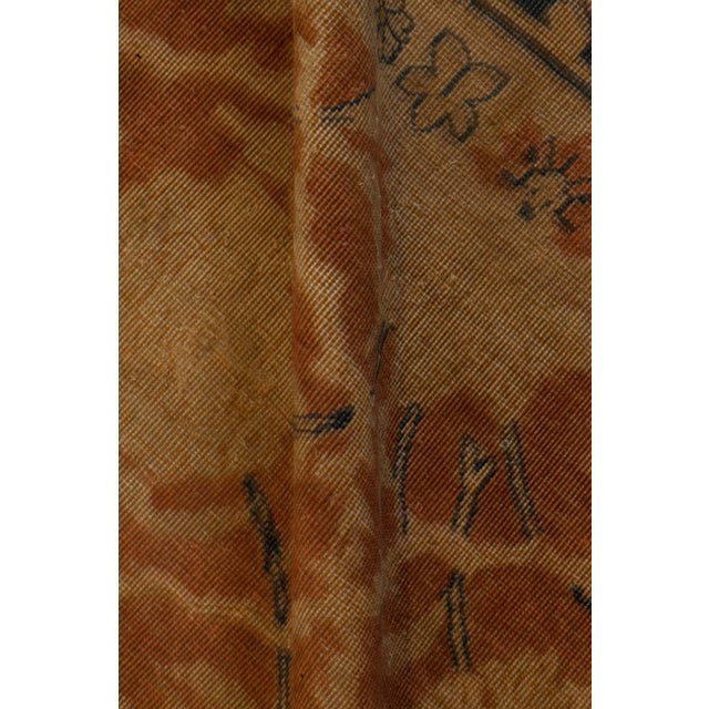 An early 20th century north Indian rug, the rust field with an allover lozenge lattice of palmettes, leafy vines and...