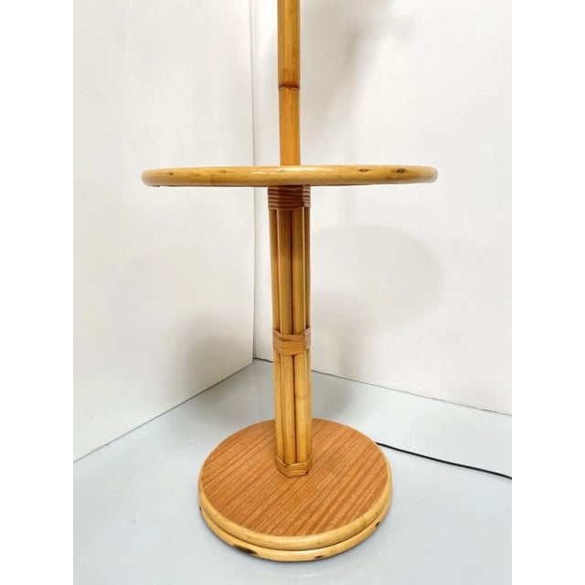 Rattan pole lamp featuring a decorative single rattan pole centered around a drink side table fixed to a mahogany and...