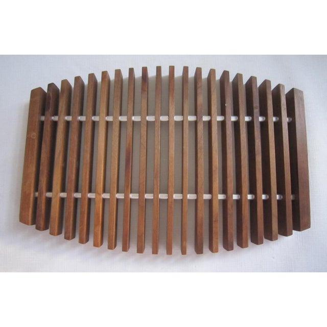 Vintage Mid Century wooden trivet approx. 13.5” long x 9"W. Super rare and unique addition to a mid century and throwback...