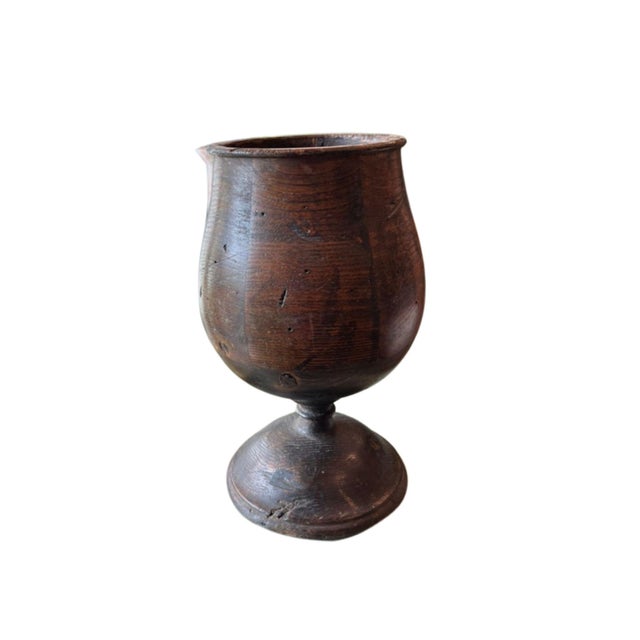 Beautifully curved footed urn vessel made of solid oak in a brown stained finish. 4" opening.