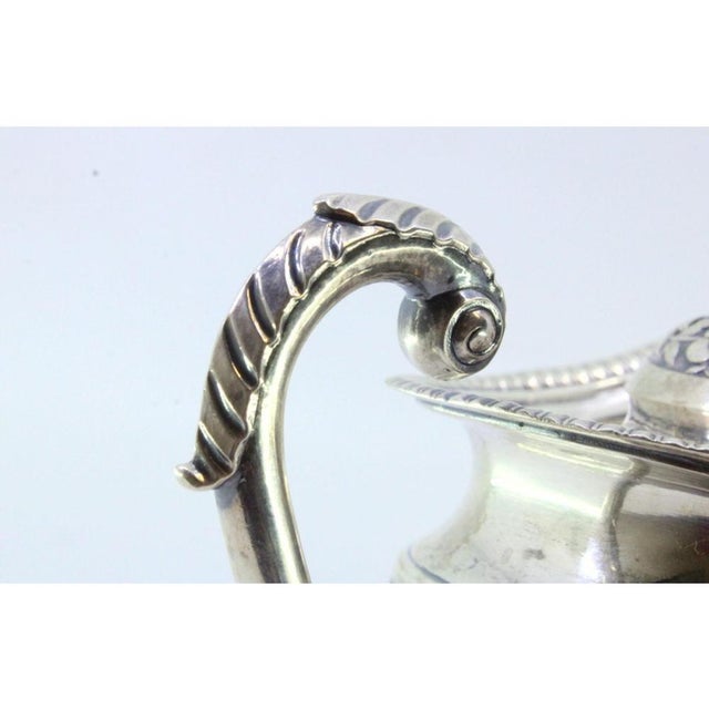 Silver Milk Jug with Raised Floral Motifs, Handle Rim Friezes, Acanthus Leaf Application and Flower-Shaped Lid Knob, in...