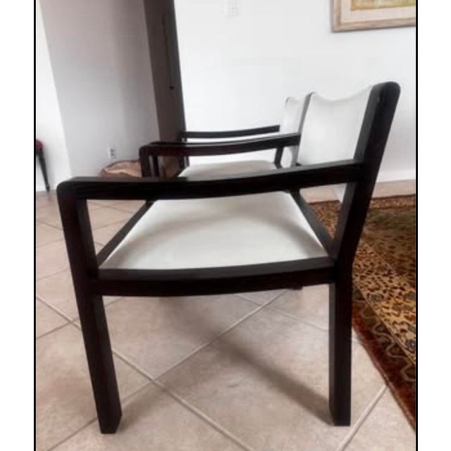 An exceptional pair of vintage, custom-made lounge chairs, individually bench-made in New York City from black walnut and...