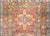 A stunning early 20th century Persian hertz runner with myriad stylized floral medallions woven in pinks, indigos, whites,...