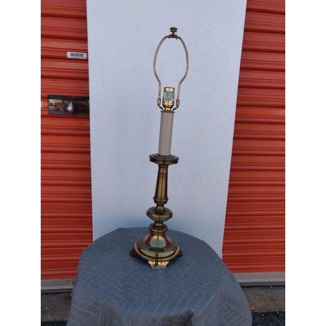 Very classic brass Colonial candlestick style lamp. It is a vintage lamp, as can be seen by the cord. The lamp works. The...