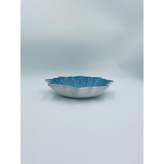 A decorative vintage bowl made of high-quality ceramic. The bowl features a distinctive star-shaped design, adorned with a...