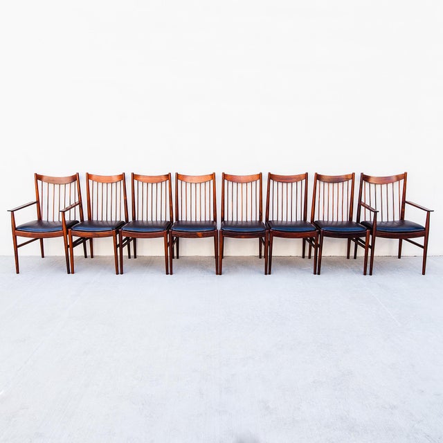 A beautifully preserved set of eight Scandinavian mid-century modern spindle-back dining chairs by Arne Vodder, produced...