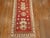 An early 20th century turkish oushak runner in a vibrant red